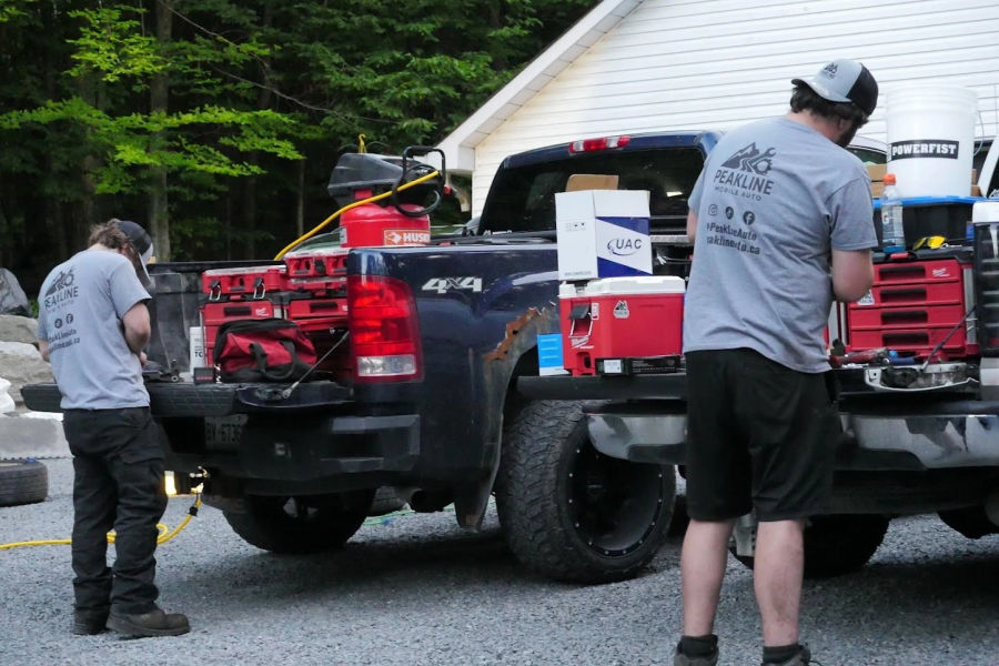 The Peakline truck bed loaded with tool cases at a job